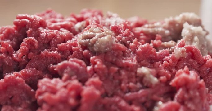 Slide shot of raw minced beef with onion, 4k prores footage