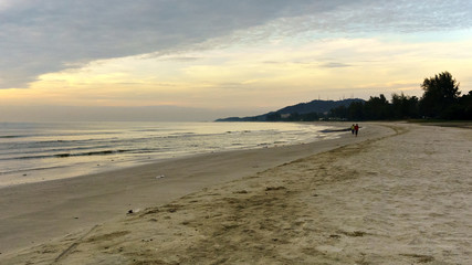 two man jogging on the beach in the early morning hours