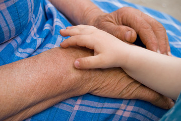 Family Values - Parenting - Grandmother's love - Kid's and Senior Woman's hands