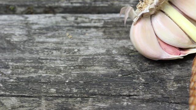 Sliced bacon, tomatoes and garlic bulb on the old wooden desk