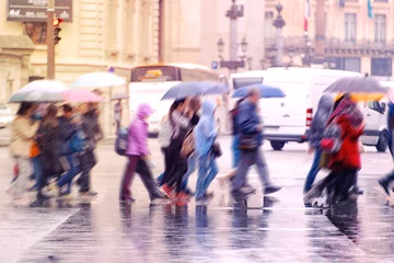 Foto op Canvas Raining day in city, crowd of people crossing a road, Paris © Savvapanf Photo ©