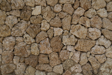 Wall of sandstone from coarse stones