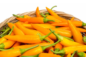 Yellow chili peppers in bamboo basket,on white background