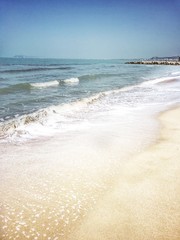 sunny day on a sandy beach on the Adriatic sea in Albania, sand and blue water. 