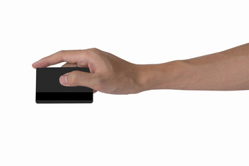 man's hand holding blank black credit card mockup with black magnetic stripe isolated with white, back side view.