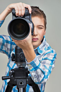 Boy with camera taking pictures