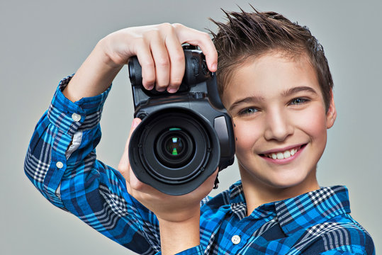 Boy with photo camera taking pictures.