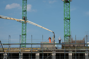 Fototapeta na wymiar construction workers pour concrete