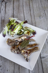 Fried lamb ribs on wood background
