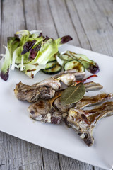 Fried lamb ribs on wood background