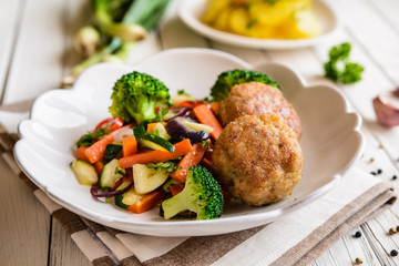 Fried pork burgers served with steamed vegetable