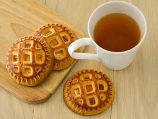 Morning tea with biscuits. On a light wooden table