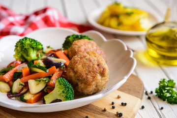 Fried pork burgers served with steamed vegetable