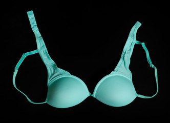 Small cyan brassiere on the black background