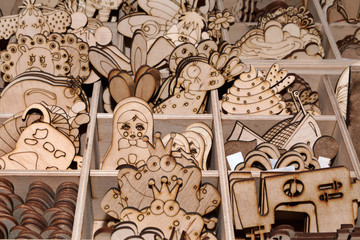 Children's coloring plywood figures at the art supplies shop for the artist