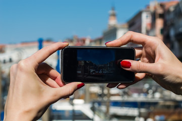 girl taking photo with her cellphone