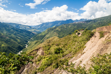 Fototapeta na wymiar Dense jungle in Yungas mountains, Bolivia. Town Coroico on th right side.