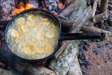 Frying bananas on a fire in a jungle of Madidi National Park, Bolivia