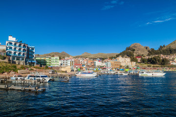 Fototapeta na wymiar COPACABANA, BOLIVIA - MAY 12, 2015: Boats in a harbor of Copacabana town on Titicaca lake, Bolivia