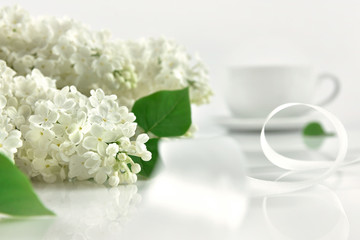 White lilac with cup of tea at the morning. Mother's day