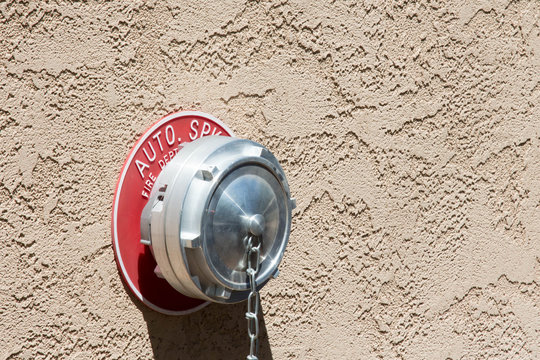 Firefighter standpipe in a stucco wall