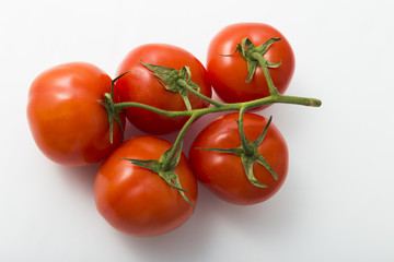 Useful vegetables tomatoes on a white background