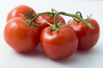 Useful vegetables tomatoes on a white background
