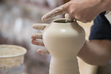 Potter makes pottery handmade in the workshop 