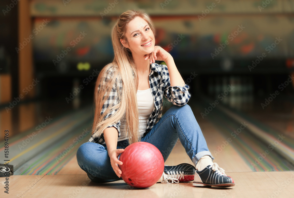 Canvas Prints Beautiful young woman with ball in bowling club