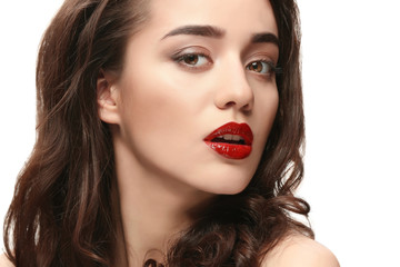 Portrait of beautiful woman with red lips on white background