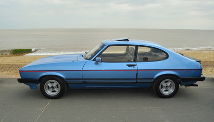 Classic Blue  Capri  Laser Motor Car Parked on seafront promenade.