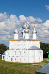 white steeple church with three domes