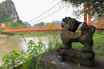 Lion figure-toll suspension footbridge-Nam Song river-Vang Vieng-Vientiane province-Laos. 4669