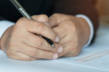 hands business holding pen on document paper in meeting office