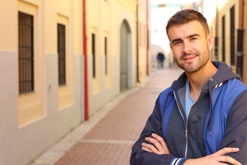 Attractive male outdoors isolated with arms crossed 