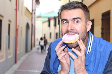 Man showing gluttony while eating dessert
