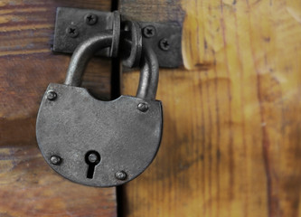 Old padlock on a wooden door