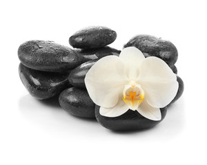 Fototapeta na wymiar Spa stones with orchid flower on white background