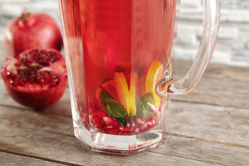 Jug with cold fruit cocktail, closeup