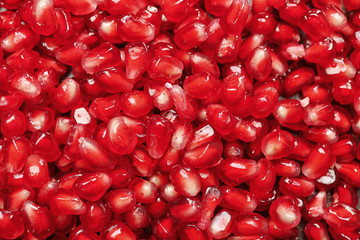 Fresh juicy pomegranate seeds as background, closeup