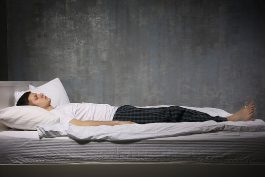 Young man sleeping in bed