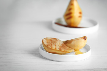Tasty pears with honey sauce on plate