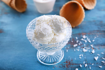 Vintage bowl with fresh coconut ice cream on table