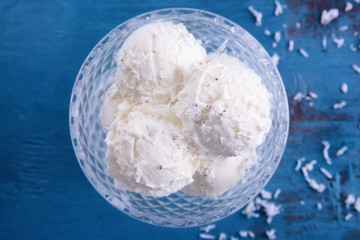Vintage bowl with fresh coconut ice cream on table