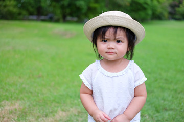 Cute Baby girl playing in the garden, close-up portrait, Portrait of Asian beautiful baby girl of 1 year and 3 months old.