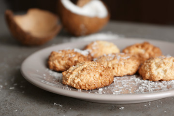 Plate with delicious coconut macaroons on table