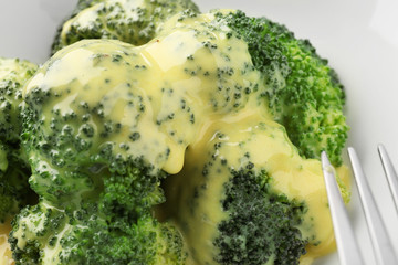 Broccoli with cheese sauce, closeup