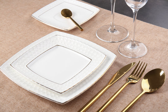 Table setting with plates and cutlery, closeup