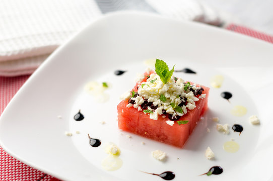 Watermelon and feta salad. This watermelon cubes salad is made with greek feta cheese crumbs, olive slices, mint, olive oil and balsamic vinegar. So refreshing, the perfect food for the summer!