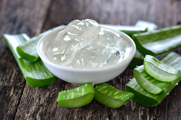 aloe vera gel in bowl with on wooden table - obrazy, fototapety, plakaty